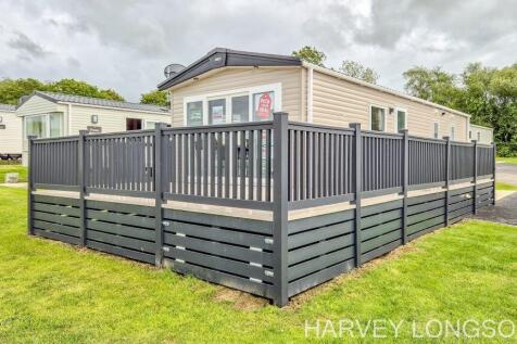 Exterior of ABI Amberley static caravan with wrapa