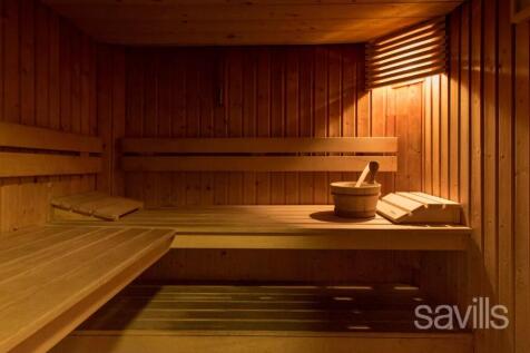 A wooden sauna interior with benches, soft lightin