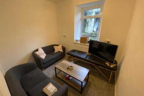Cozy living area with modern sofas and window...