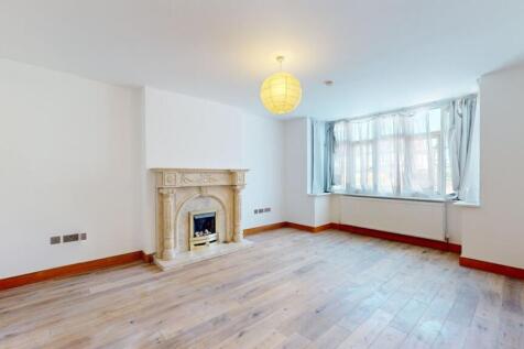 Bright spacious lounge with a classic fireplace...
