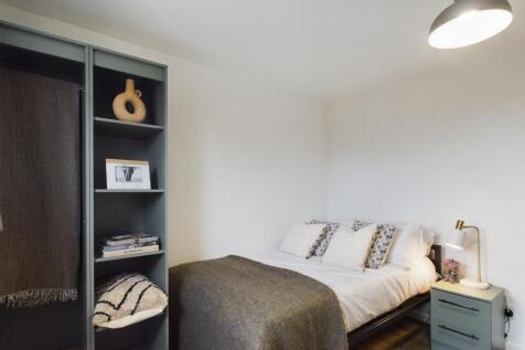 A cozy and well-maintained bedroom featuring a ...