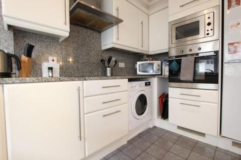 Modern fitted kitchen with integrated appliance...