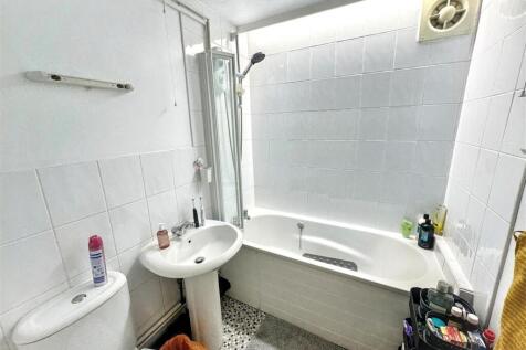 Bright bathroom with combined bath and shower...
