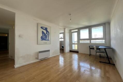 Bright living room with large windows, wood flo...