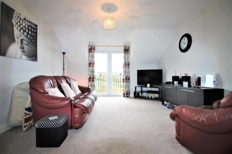 Bright living area with French doors and sofas...