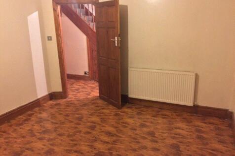 Empty living room with patterned laminate floor...