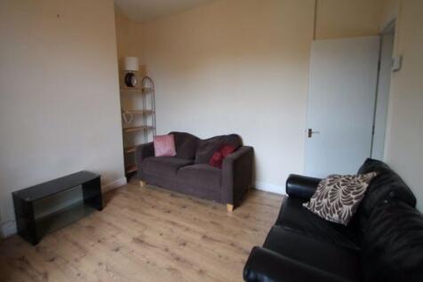 A spacious and welcoming living room featuring ...