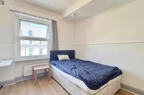 Bright and airy bedroom with modern wood floors...