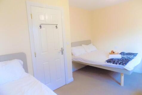 A bright and tidy double bedroom featuring two ...