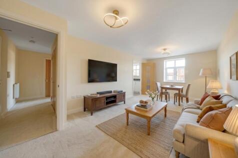 a living room with a tv and couches