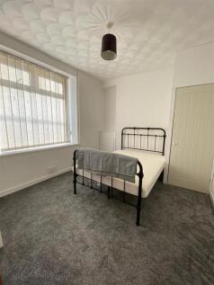 Bright double bedroom with modern grey carpets ...