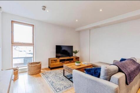 Bright, modern living room with a large window,...