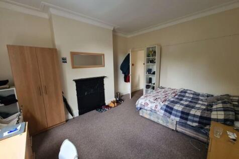 A spacious master bedroom featuring a large dou...