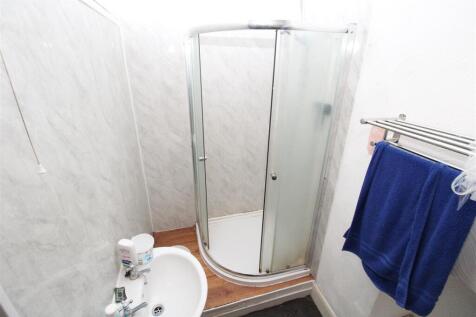 Bright bathroom with modern curved shower cubic...