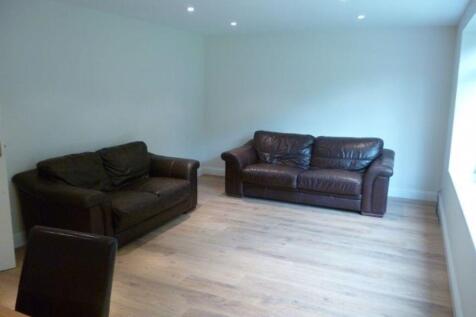 Bright, minimally furnished living room with li...