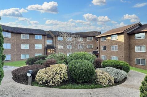 Modern building with lush landscaped grounds...