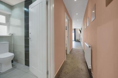 Bright, modern hallway with warm pastel walls...