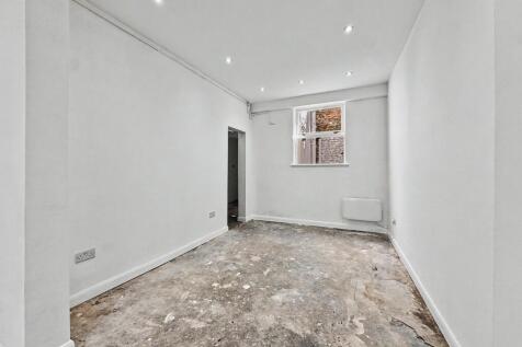 Bright, open room with spotlights and neutral w...