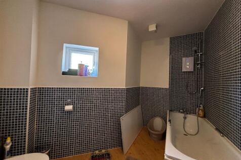 Spacious bathroom suite with shower over bath...