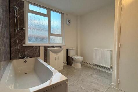 Bright, modern bathroom with bath and shower...