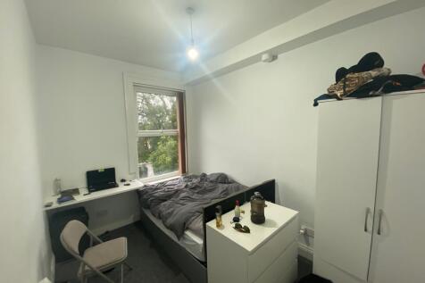 Bright bedroom with integrated desk and storage...