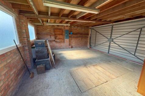 Double garage with up and over door onto rear lane