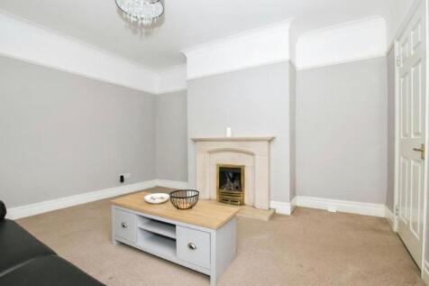 Bright, neutral living room with a decorative f...