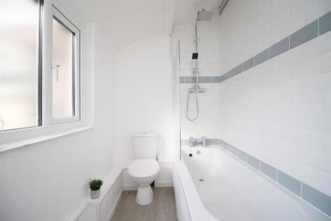 Bright bathroom with modern tub and large windo...