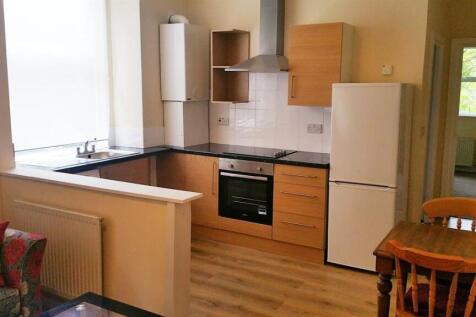 Bright kitchen with modern appliances and dinin...