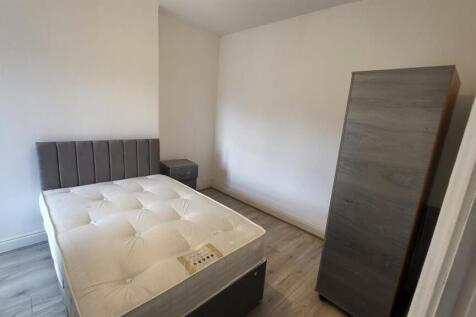 Bright bedroom with stylish wooden flooring...