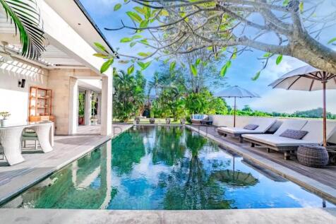 A serene outdoor space featuring a sleek swimming 