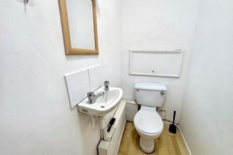 Clean single toilet with basin and mirror...