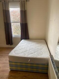 Bright double bedroom with wooden flooring...