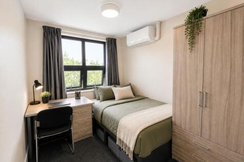Modern room with study desk and ample storage...