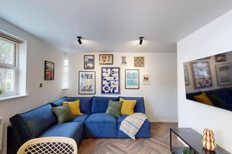 Bright, stylish living room with a comfy blue L...