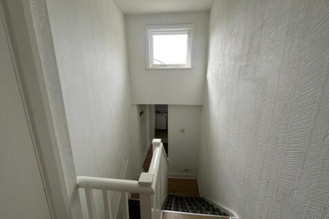 Bright painted stairwell with natural window li...