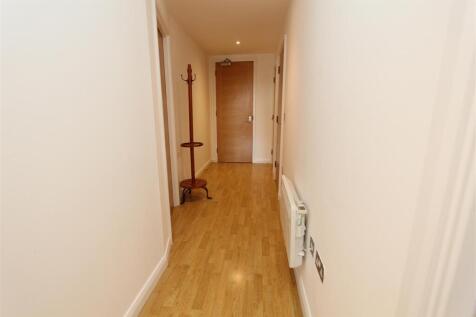 Bright modern hallway with sleek wood flooring...