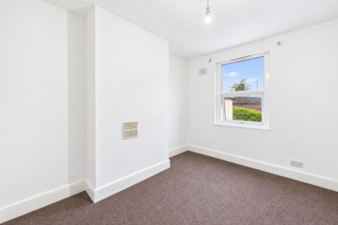 Empty white-walled room in soft daylight