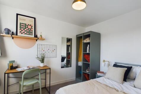 This inviting double bedroom features a stylish...