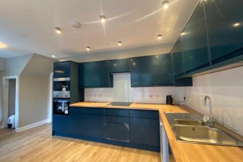 A modern and clean kitchen with blue cabinets a...