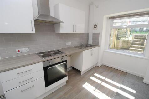 Modern bright kitchen with sleek white cabinets...