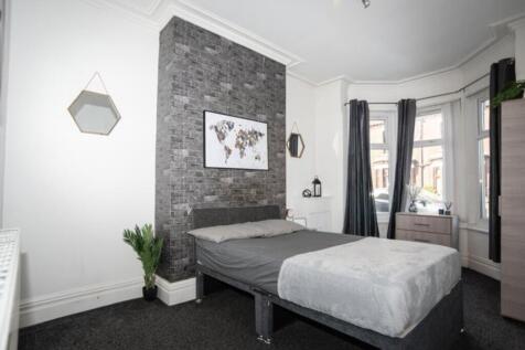 This charming double bedroom features a stylish...