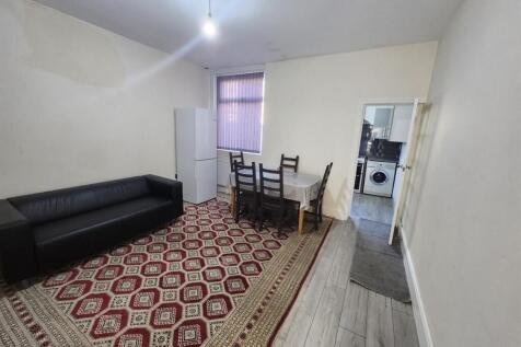 Bright shared living room with a large patterne...
