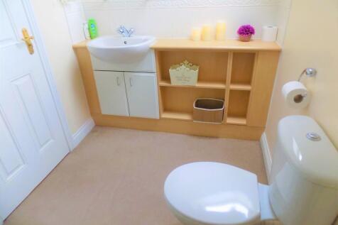 Bright and clean bathroom featuring a white toi...