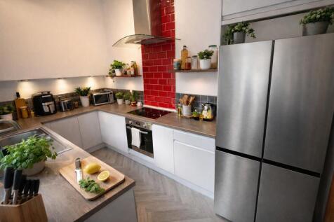 Modern U-shaped kitchen with stainless-steel ap...