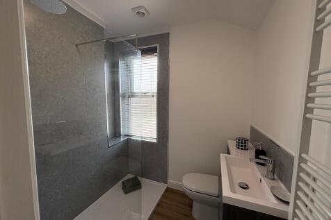 Modern bathroom with a large walk-in shower, ra...