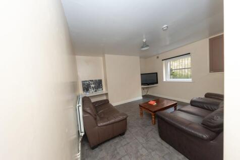 A cozy living room featuring two brown leather ...