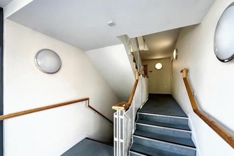 Clean and well-lit modern staircase area...