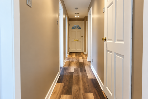 Warm Beige Hallway with Brass-Accented Front Door
