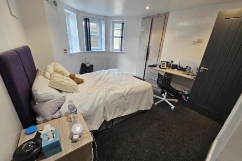 A cozy and well-maintained bedroom featuring a ...